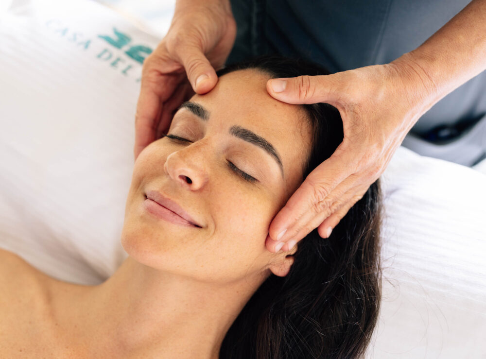woman on the spa table getting a head massage