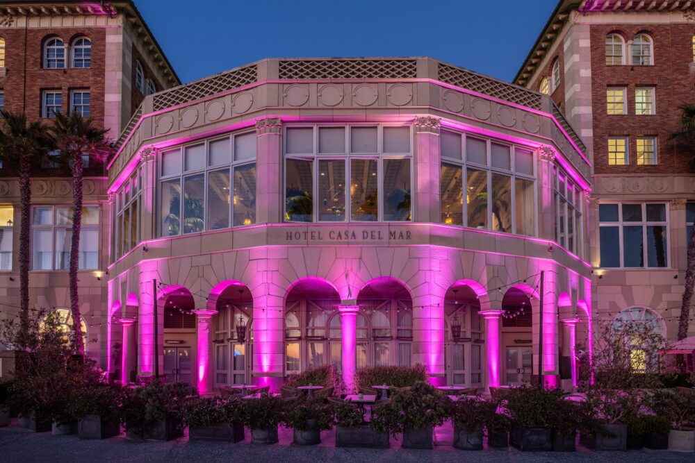 purple lights shining on the exterior of the hotel