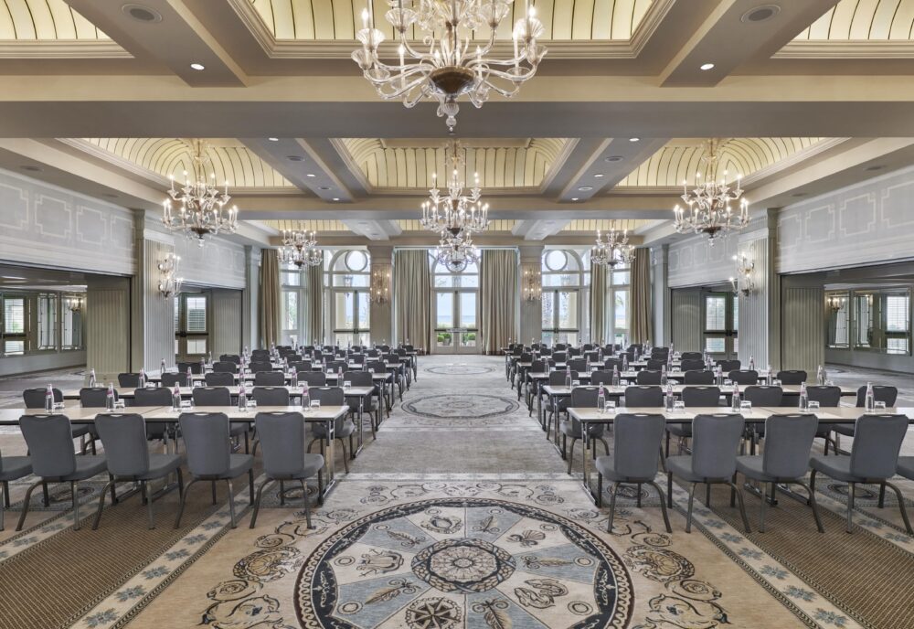 Colonnade Ballroom with several chandeliers, rows of tables and chairs set up for a meeting
