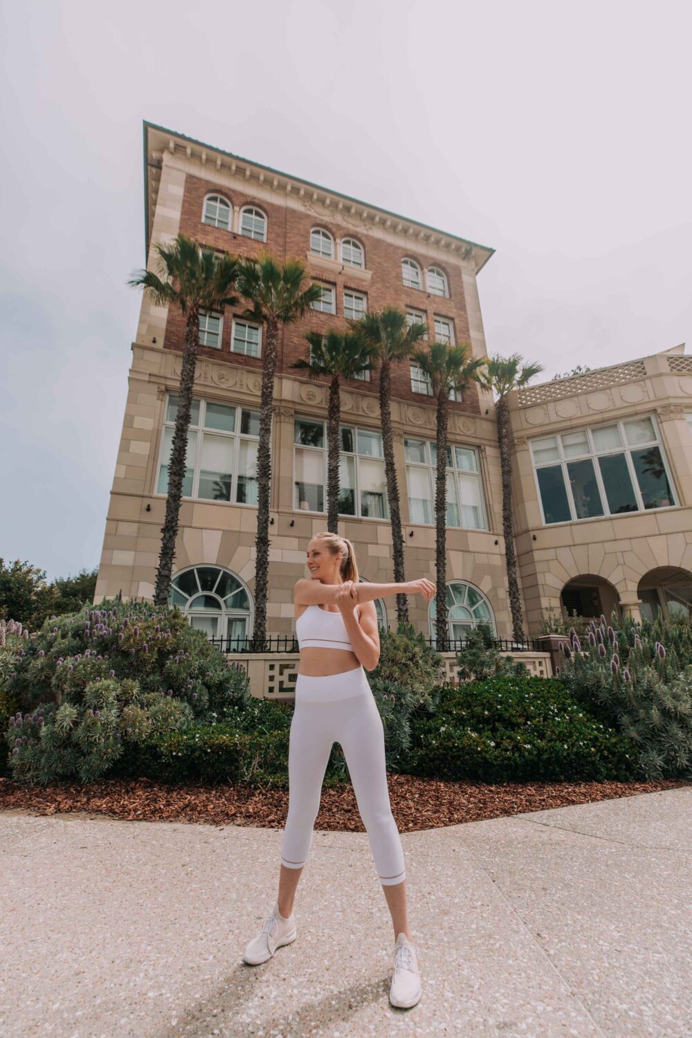 woman stretching before her run outside of the hotel