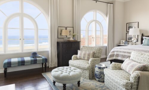 Penthouse shot of windows and a seating area looking towards the beach