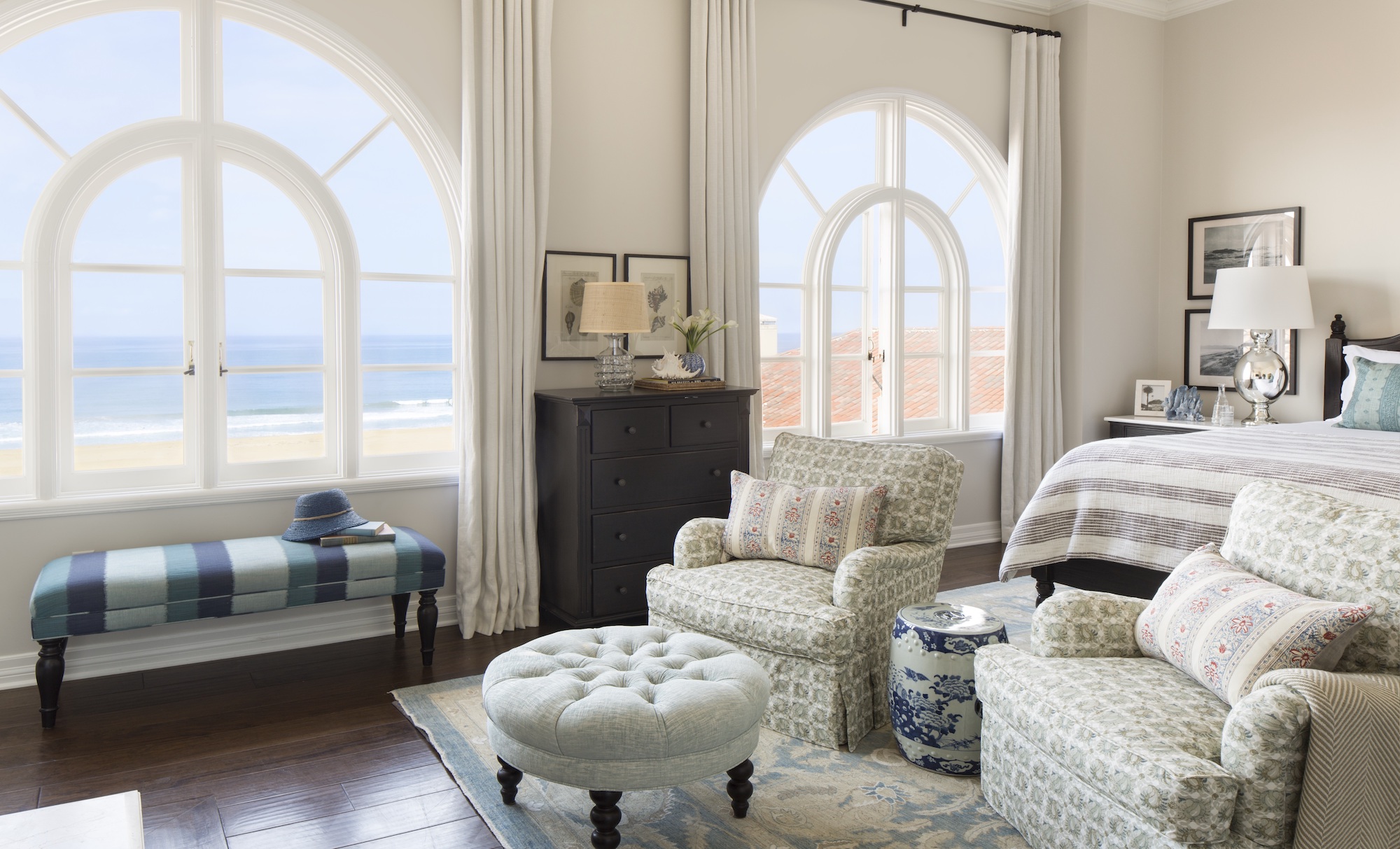 Penthouse shot of windows and a seating area looking towards the beach