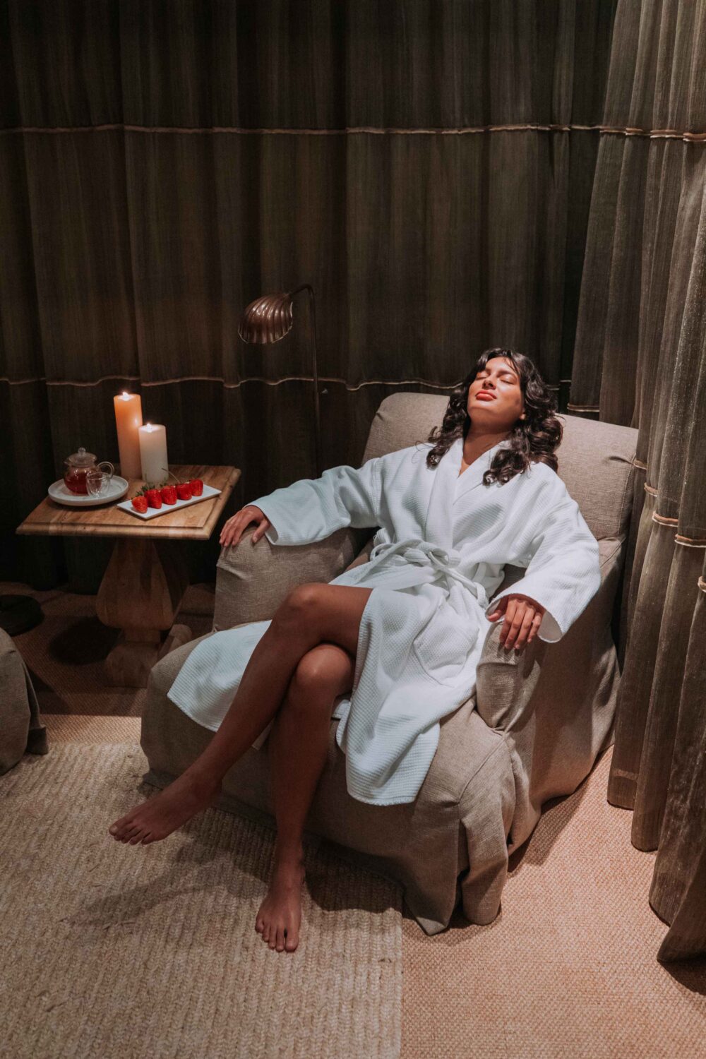 woman reclining on a chair in a robe in the spa seating area